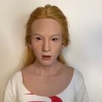 Adam realistic silicone female mask with blonde hair and chest plate front view
